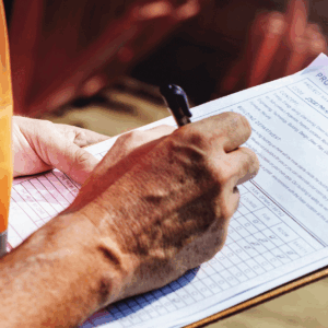 Worker assessing quality control with a clipboard